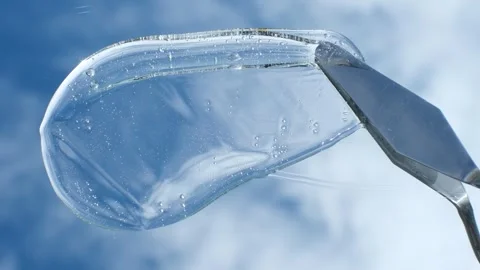 Female hand using spatula applies smear of shampoo or shower gel against the Stock Footage 250297854