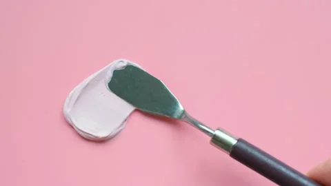Female hand using spatula makes a smear of cosmetic clay close-up top view on a Stock Footage 237741813
