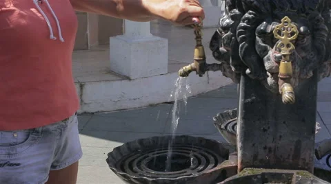 Female hand washes under the tap in the street Stock Footage 67871899