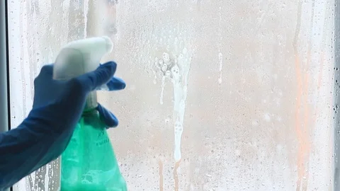Female hand washes a window with rag in the flat Stock Footage 99806847