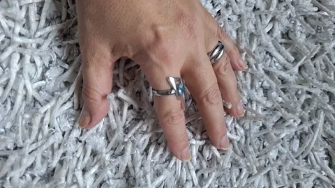 Female hand on a wheit background. Series. Video stock 346492736
