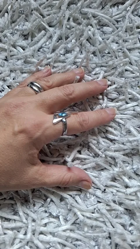 Female hand on a wheit background. Series. Video stock 346492958