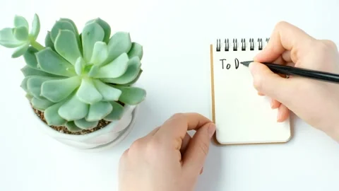 Female hand writes To Do List in notepad on white background, planning concept. Stock Footage 236898297