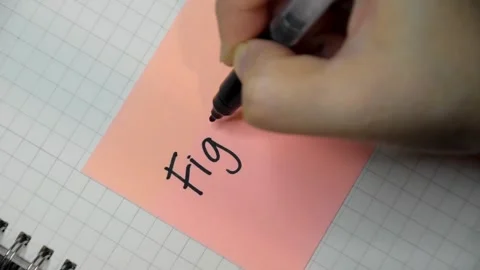 Female hand writes down a message with black pen on a sticky note. Stock Footage 346005989