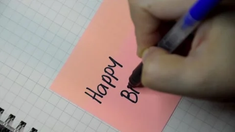 Female hand writes down a message with black pen on a sticky note. Stock Footage 346006022