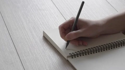 Female hand writes a note in a notebook. A letter to a friend. Stock Footage 61913418