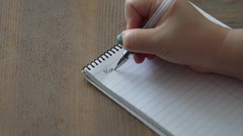 Female Hand Writing First Day Of The Week "Monday" On Notepad Video stock 344514393