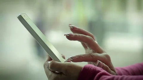 Female Hand Writing a Message on Smart Phone Near the Window Stock Footage 72745045