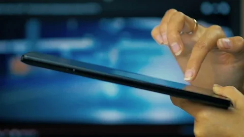 Female hand writing a message on a tablet on a laptop screen background. Stock Footage 81522979