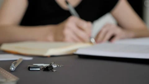 A female hand writing notes in notepad. Doing homework. Stock Footage 130667027