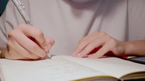 Female hand writing using black pen to put thoughts on paper of daily journal 動画素材 163251787