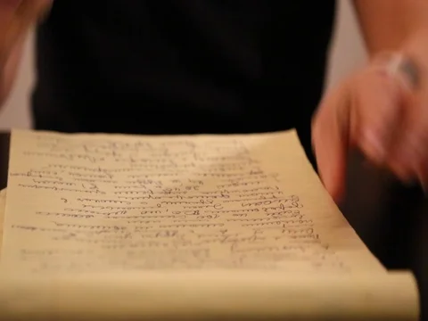 Female hand writing yellow notebook Stock Footage 73306957