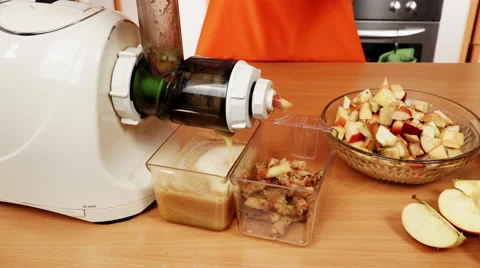 Female hands adding apple fruits in juicer machine 4K Stock Footage 61284890