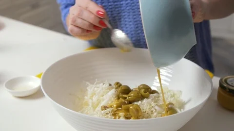 Female hands adding sauce on salad with Chinese cabbage and olives Stock Footage 125481574