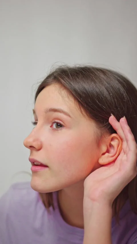 Female hands applying hand to ear, symbolizing attentiveness and listening Stock Footage 305509560