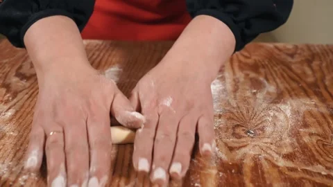 Female hands are preparing dough decorations for Easter bread, close-up. Cooking Stock Footage 253917192