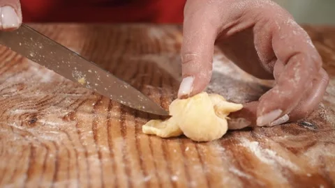 Female hands are preparing dough decorations for Easter bread, close-up. Cooking Stock Footage 253917343
