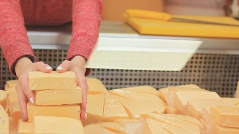 Female hands are sorting cheese in the refrigeration equipment of the store Stock Footage 118123307