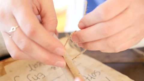 Female hands are tying a scroll of paper Stock-Footage 143687964