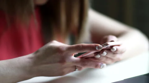 Female hands are typing text into the phone 스톡 동영상 165515630