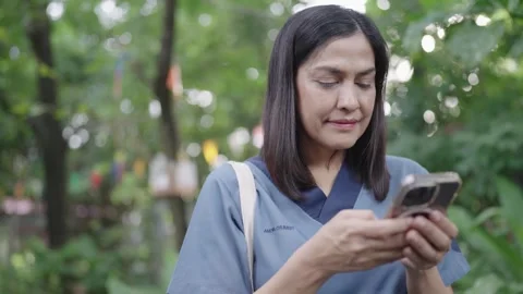 Female hands are using mobile phones to type chat and send messages to friends i Stock Footage 252735061