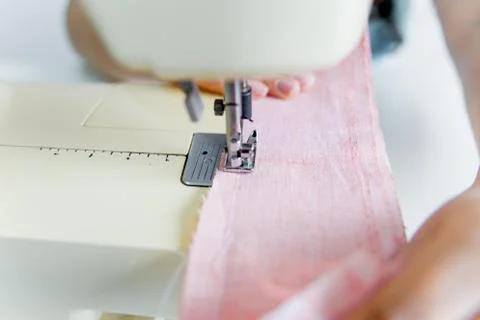 Female hands are using a sewing machine Stock Photos