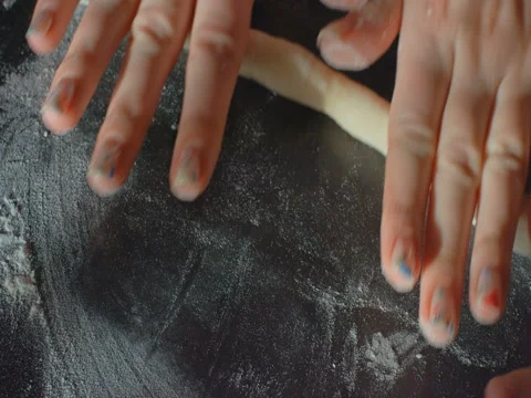 Female hands are working with dough Stock Footage 84635656