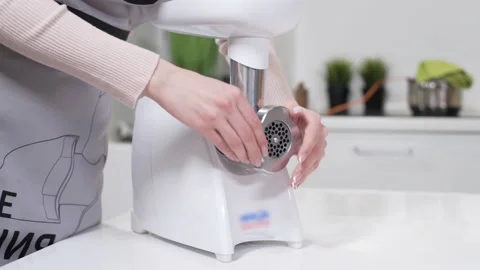 Female hands assembles meat grinder head for providing quality mince from meat Stock Footage 130248057