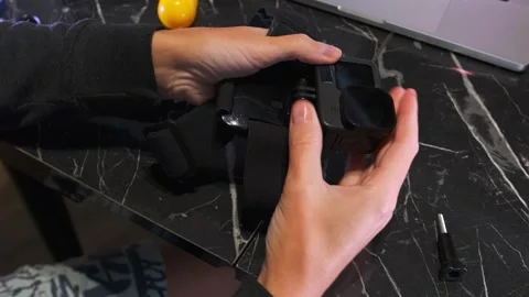 Female hands attaching head mount to action camera close-up, securing strap and Stock Footage 333478889
