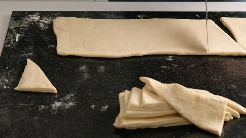 Female hands of a baker cut the dough with a thin knife in the home kitchen Stock Footage 128076085