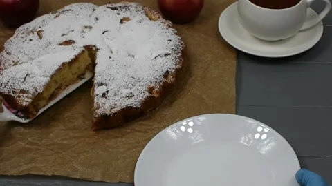 Female hands in blue gloves shift a sliced piece of apple pie on a white plate. Stock Footage 153550291