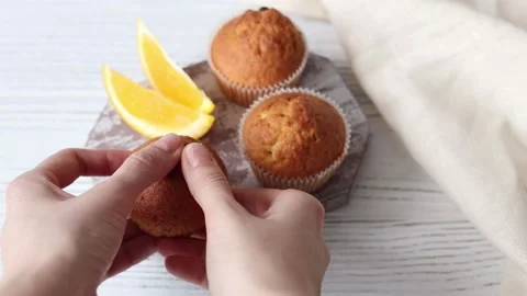 Female hands breaking fresh baked muffin Stock Footage 151512349