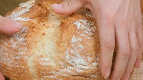 Female hands breaking homemade bread. Stock Footage