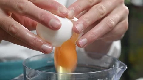 Female hands breaks an egg. Stock Footage 246860938