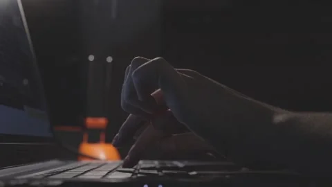 Female hands carefully typing on computer keyboard late at night in dark room in Stock Footage 161037986