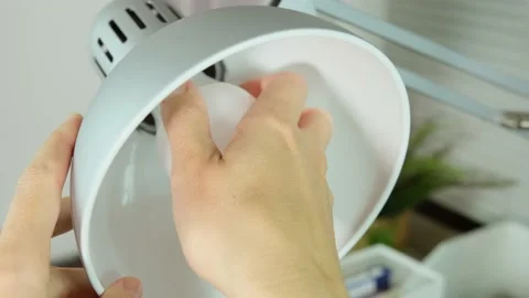 Female hands changing, replacing a led light bulb in office, screwing in the Stock Footage 140725623
