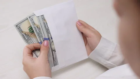 Female hands checking dollar bills in envelope, witness bribing, illegal salary Stock Footage 194669294