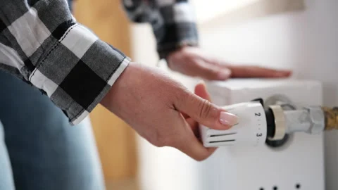 Female Hands Checking Temperature And Adjusting Heater Video stock 323965093