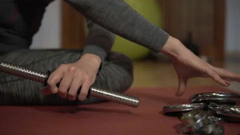 Female hands choosing dumbbells on the rack in gym. Stock Footage 101024330