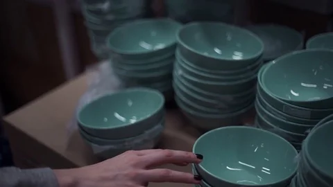 Female hands choosing plates in the section of dishware in housewares store Stock Footage 83432971