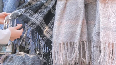 Female hands choosing a warm winter scarf with a fringe Stock Footage