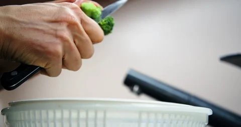 Female hands chopping, preparing fresh vegetables, broccoli in kitchen Stock Footage 123550184