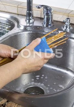 Female hands cleaning chopsticks Stock Photos