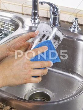 Female hands cleaning drinking glass Stock Photos