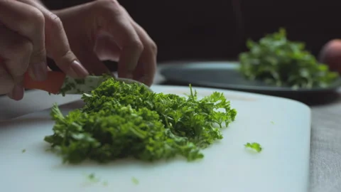 Female hands close up cut parsley, prepare a vegetarian salad Stock Footage 135257527