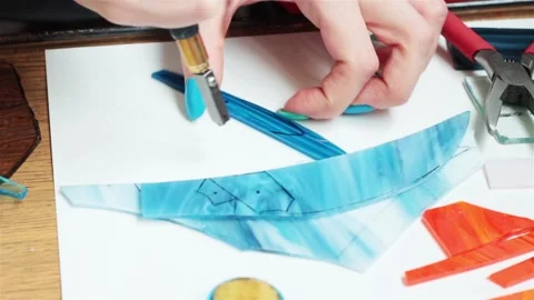 Female hands close up cutting multicolored glass to make adornment bijouterie  Video stock 89756310