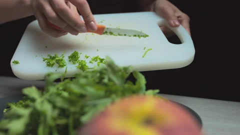 Female hands close up pour green salad into a bowl, prepare a vegetarian salad Stock Footage 135257535