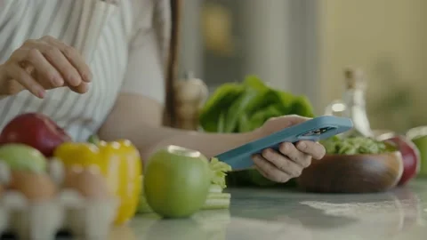 Female hands in close-up using mobile phone to search for recipe for healthy 스톡 동영상 236054559