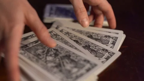 Female hands collect a deck of Tarot cards in a pile Stock Footage 162986170