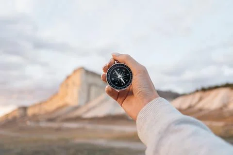 In female hands Compass in the background, mountain 'Cliff White'. Stock Photos